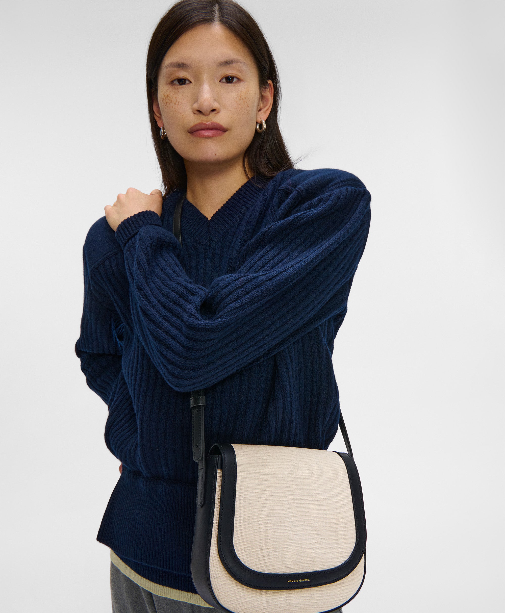 Model wears the Classic Crossbody in Natural Canvas