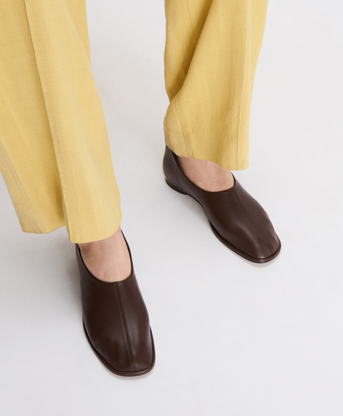 Model wears Glove Slip On in Chocolate