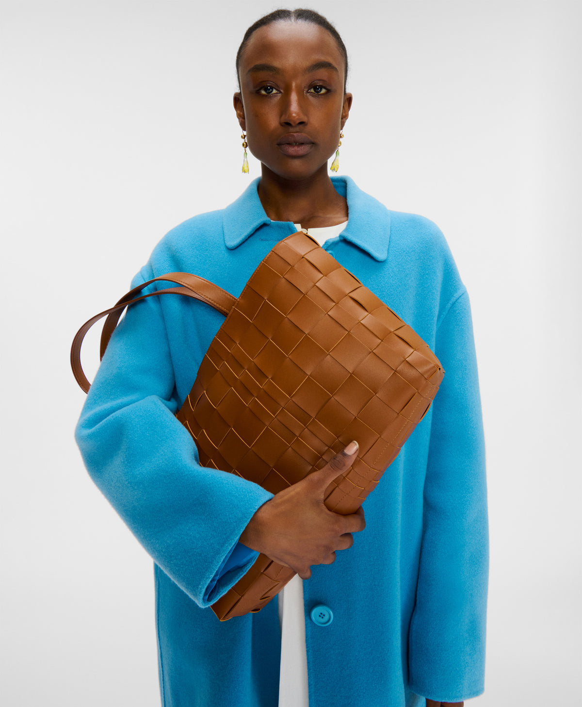 On model of the Upcycled Woven Leather Tote in camel